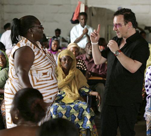 Irish pop star Bono, right, speaks to Ghanaian women involved in a micro-finance project during a meeting held at a local market in Accra, Ghana, May 24, 2006. Bono, the international rock star who has helped bring worldwide attention to medical and econo The Associated Press
