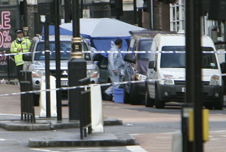 A British police forensic officer leaves a blue operations tent that police placed over a vehicle which contains a suspected bomb in the Haymarket area near Piccadilly Circus in central London, Friday June 29, 2007. Explosives officers on Friday dealt wit The Associated Press
