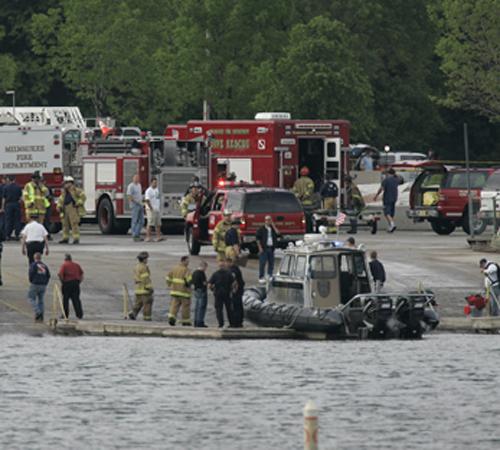 Rescue personnel assemble on the McKinley Marina boat launch as they help search for a plane that went down in Lake Michigan Monday, June 4, 2007, in Milwaukee. A medical transport plane carrying six people went down Monday afternoon shortly after the pil The Associated Press
