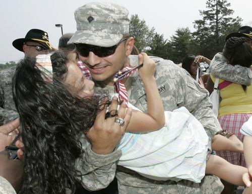 National Guardsman Carlos Cabezas, of Union, N.J., hugs his daughter Kaira, 5, as he arrived at Fort Dix, N.J., on Tuesday as two guard units returned home after being deployed in Iraq for almost two years. The Army is deliberating on whether to extend tr Mike Derer, The Associated Press
