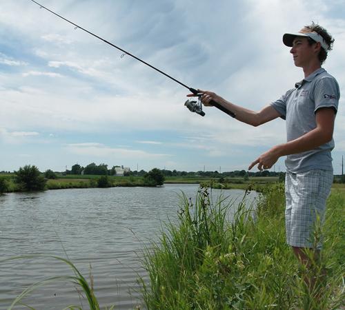 Tom Gardner, 19, of Urbana, fishes at a pond on the corner of First and Windsor on June 22, 2007. Steve Contorno
