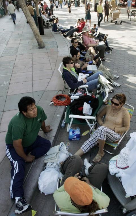Martin Perez, left, and Erika Puquirre, right, of Los Angeles are at the head of a line of about 30 people - as of 5 p.m. Pacific Coast time - in front of an Apple Store on the Third Street Promenade in Santa Monica, Calif., waiting for the introduction o The Associated Press

