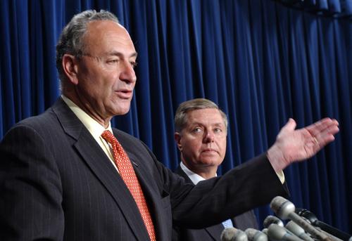 Sen. Charles Schumer, D-N.Y., left, accompanied by Sen. Lindsey Graham, R-S.C., right, gestures during a news conference on Capitol Hill in Washington, Wednesday, June 27, 2007, to discuss an amendment to the immigration bill which would require biometic Phil Collins
