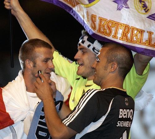 Real Madrid players David Beckham from England, left, Iker Casillas from Spain, center and Fabio Cannavaro from Italy, right, celebrate on their bus at Cibeles square after winning Spanish soccer league title in Madrid, Monday, June 18, 2007. Real Madrid Alvaro Barrientos, The Associated Press
