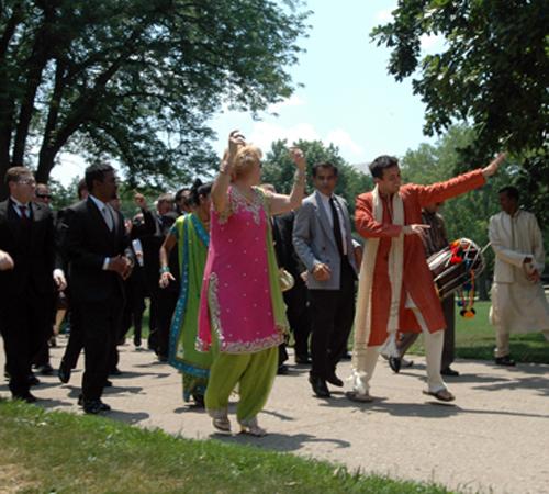 Nitin Mehdiratta, in red, friend of Shefali Gopal, leads the groom Christopher Malik in a traditional Indian wedding procession on the Quad on Saturday, June 16, 2007. The dance that Mehdiratta performed could be considered Bhangra, as he led the groom an Maria Surawska
