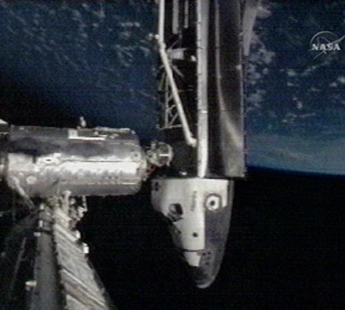 In this image made from video provided by NASA, the Space Shuttle Atlantis is seen docked with the international space station in orbit, with the Earth seen above. The Associated Press
