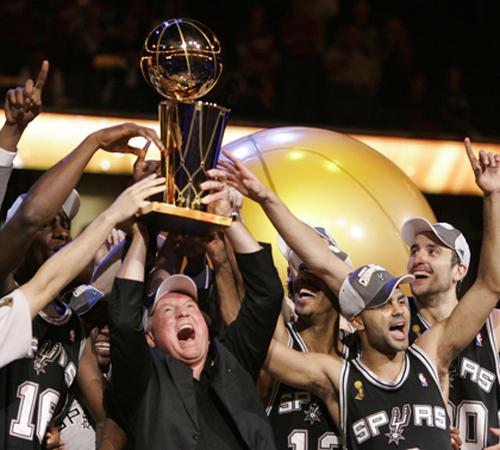 Spurs CEO Peter Holt, center, holds up the NBA Championship trophy as he celebrates with the team after Game 4 of the NBA basketball finals Thursday, June 14, 2007, in Cleveland. The Spurs clinched the championships in four games defeating Cleveland, 83-8 Steve Contorno
