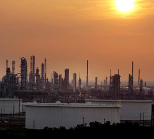 The sun begins to set over an oil refinery in Port Arthur, Texas, in this May 17, 2007 file photo. A push from Congress and the White House for huge increases in biofuels such as ethanol, is prompting the oil industry to scale back its plans for refiner LM Otero, The Associated Press
