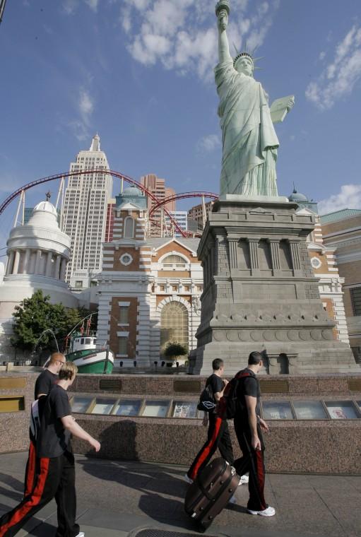 People walk past the New York-New York hotel-casino in Las Vegas, Friday, July 6, 2007. A man on a walkway over the New York-New York casino floor opened fire on the gamblers below early Friday, wounding three people before he was tackled by a group of of The Associated Press
