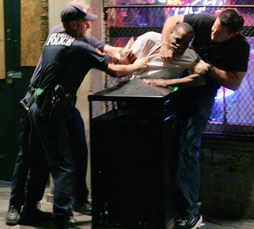 Police officers subdue a man later identified as Robert Davis on Conti Street near Bourbon Street in the French Quarter of New Orleans Saturday night, Oct. 8, 2005. At least one police officer repeatedly punched the 64-year-old Davis, accused of public in Mel Evans, The Associated Press
