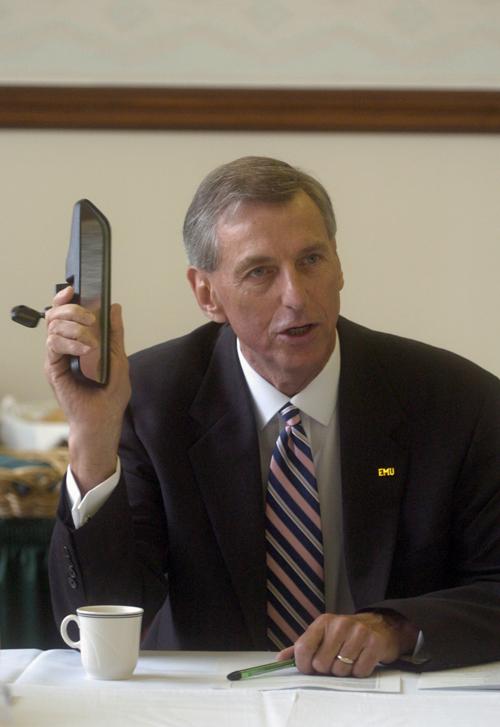 astern Michigan University president, John Fallon holds up a rear-view mirror in this July 18, 2005, file photo taken in Ypsilanti, Mich., during a breakfast meeting with student leaders, saying that his first decision as a president was to take off the Eliyahu Gurfinkel, The Associated Press
