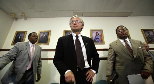 Regent Floyd Clack, left, Chairman Thomas Sidlik, center, and Regent James Stapleton leave a news conference on the firing of Eastern Michigan President John Fallon in Ypsilanti, Mich., on Monday. David P. Gilky, The Detroit Free Press for the Associated Press
