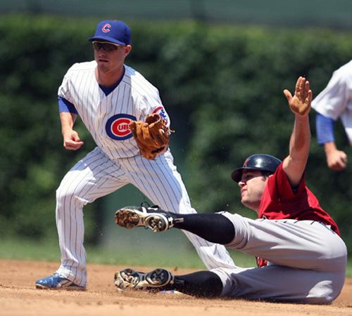 Mike Fontenot fails to get the tag on Houston Astros first baseman Lance Berkman on Sunday. The Cubs, down five runs in the second inning, came back to win 7-6. Joseph Oliver, The Associated Press
