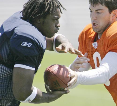 Chicago Bears quarterback Rex Grossman, right, hands off to running back Cedric Benson during practice at Olivet Nazarene University in Bourbonnais, Ill., Monday, July 30, 2007, during the fourth day of football training camp. M. Spencer Green, The Associated Press
