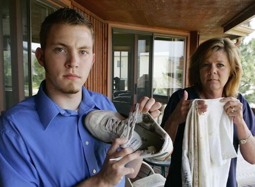 Jason Bunch, 18, holds his lightning burned shoe and his mother Kelly Risheill his burned shirt at their home in Castle Rock, Colo., on Wednesday, July 11, 2007. Bunch was wearing the shoe and shirt and an Ipod when he was struck by lightning last July wh Ed Andrieski, The Associated Press
