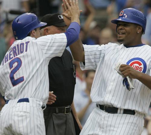Ryan Theriot and Daryle Ward high five after scoring on a two-RBI single by Aramis Ramirez during the first inning against the San Francisco Giants on Thursday in Chicago. With the victory, Cubs starter Ted Lilly, who allowed three runs over five innings M. Spencer Green, The Associated Press
