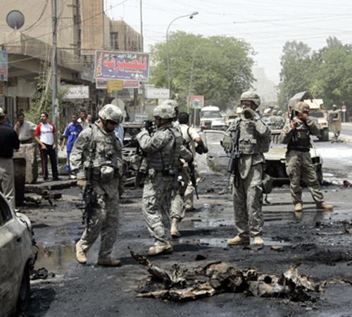 U.S. soldiers investigate the site of a car bomb attack in the Karradah neighborhood in central Baghdad, Iraq, Monday, July 23, 2007.Three parked cars exploded in a predominantly Shiite area in Baghdad on Monday, killing at least 12 people and wounding 19 Khalid Mohammed, The Associated Press
