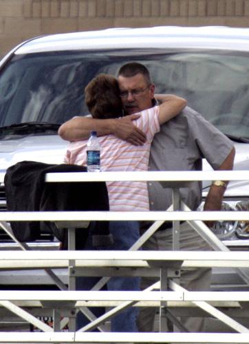 Two unidentified people hug in a designated area for trapped miners relatives at a junior high school Friday, Aug. 17, 2007 in Huntington, Utah. The search for six miners missing deep underground was abruptly halted after a second cave-in killed three res Rick Bowmer, The Associated Press
