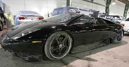 A damaged black Lamborghini registered to Chicago Bears football player Lance Briggs is shown in a garage in Morton Grove, Ill., on Monday. Illinois State Police said the 2007 Roadster crashed into a pole at 3 a.m. THE ASSOCIATED PRESS, M. SPENCER GREEN
