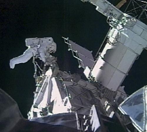 In this photo made from the NASA-TV, Canadian Space Agency astronaut Dave Williams works outside of the Space Shuttle Endeavour during a space walk while orbiting Earth, Saturday, Aug. 11, 2007. This is the first space walk of the STS-118 mission, which i NASA-TV from The Associated Press
