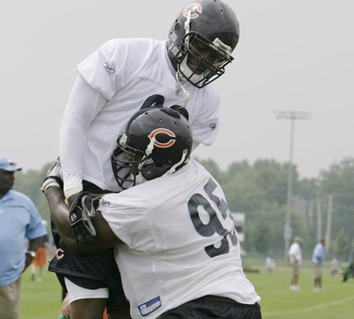 Chicago Bears defensive tackle Anthony Adams lifts defensive end Adewale Ogunleye off his feet during blocking drills at Olivet Nazarene University, Saturday, July 28, 2007, in Bourbonnais, Ill., during the second day of football training camp. M. Spencer Green, The Associated Press
