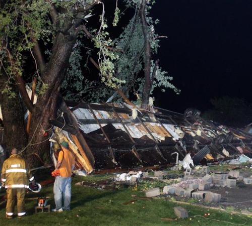 Rescue workers wait while a mobile home that was blown off its foundation by a tornado is stabilized before searching for victims inside Sunday, Aug. 26, 2007, in Northwood, N.D. The tornado destroyed the mobile home park, killing one person, and blew out John Sternness, Grand Forks Herald
