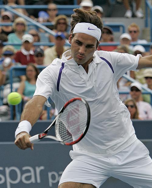Roger Federer volleys against James Blake in the championship match at the Western & Southern Financial Group Masters tennis tournament on Sunday in Mason, Ohio. Federer won his 50th career title, 6-1, 6-4, becoming the fourth-youngest player to reach the THE ASSOCIATED PRESS, AL BEHRMAN
