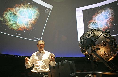 Samuel Widmann, head of Google Maps and Google Earth, gestures during a presentation of Google Earth Sky at a planetarium in Hamburg, Germany, on Wednesday. Google Earth introduced the new feature Sky, a virtual telescope which enables Internet users THE ASSOCAITED PRESS, FABIAN BIMMER
