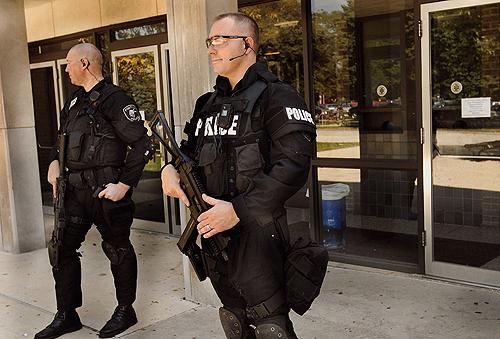 Pontiac police officers guard the side door of Pontiac Township High School Tuesday after a lock down at the school amid reports that weapons were taken into the building, according to officials. THE ASSOCIATED PRESS, DAVID PROEBER
