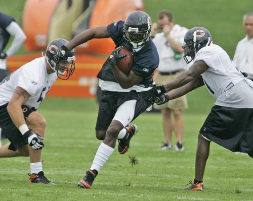 Chicago Bears wide receiver Mark Bradley eludes Brian Urlacher, left, and Nathan Vasher during passing drills at football training camp in this July 28, 2007 photo, in Bourbonnais, Ill. Bradley had a torn anterior cruciate ligament as a rookie two years a M. Spencer Green, The Associated Press
