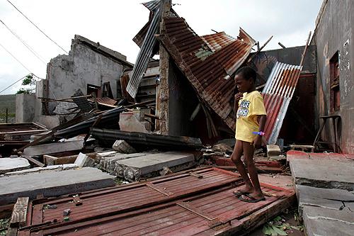 A child walks by the rubble of a shop destroyed by the strong winds of Hurricane Dean in the south central village of Mitchell Town, Jamaica, on Monday. Jamaica avoided a direct hit when the storm passed to the south Sunday night and no deaths were report THE ASSOCIATED PRESS, ADRES LEIGHTON

