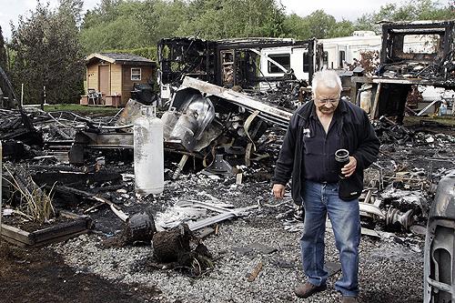A resident of a Surrey, British Columbia, trailer park surveys the damages after a hot air balloon crashed into a mobile home on Saturday. Two people were killed and 11 people were injured in the accident. THE ASSOCIATED PRESS, RICHARD LAM
