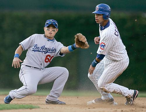 Ronny Cedeno, right, slides safely into second base as Los Angeles shortstop Chin-Lung Hu applies a late tag during the eighth inning at Wrigley Field in Chicago on Monday. THE ASSOCIATED PRESS, BRIAN KERSEY
