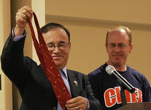 Thomas Shortbull, president of Oglala Lakota College, removes his tie which he would give to Tom Livingston, a former portrayer of Chief Illiniwek. Laura Prusik
