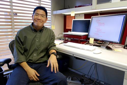 David Huong, asst. professor in HRE, sits in his office Thursday. Huong is currently doing research, advising, or working on instructional video games, which are part of one of his current projects. Erica Magda
