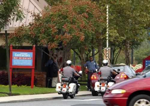 Dover police pass the main entrance of Delaware State University, Friday, Sept. 21, 2007 in Dover, Del. Two students were shot and wounded, one seriously, at Delaware State University early Friday, and the campus was locked down as police searched for a g Gary Emeigh
