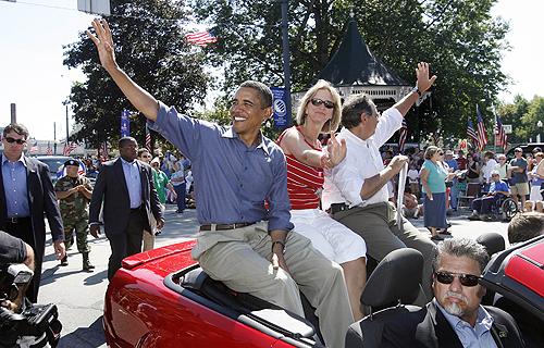 Democratic presidential hopeful, U.S. Sen Barack Obama, D-Ill., left, waves with Peggo Hodes and U.S. Rep. Paul Hodes, D-N.H., as they ride in the Labor Day parade in Milford, N.H., on Monday. THE ASSOCIATED PRESS, JIM COLE
