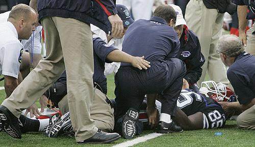 Buffalo Bills reserve tight end Kevin Everett is helped by trainers after an injury during the second half against the Denver Broncos on Sunday. Everett had surgery Sunday after injuring his spine on a kickoff. THE ASSOCIATED PRESS, DAVID DUPREY
