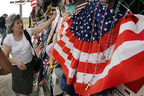 Yachiyo Kuge, mother of Toshiya Kuge, a passenger on United Flight 93 from Japan, places a momento at the Flight 93 National Memorial at Shanksville, Pa., on Monday on the eve of the sixth anniversary of United Flight 93 crashing there on Sept. 11, 2001. THE ASSOCIATED PRESS, GENE J. PUSKAR
