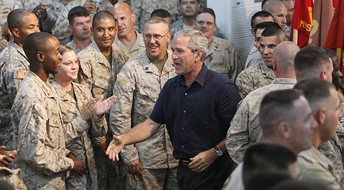 President Bush greets troops at Al-Asad Airbase in Anbar province on Monday as part of an unannounced visit to Iraq. THE ASSCOCIATED PRESS, CHARLES DHARAPAK
