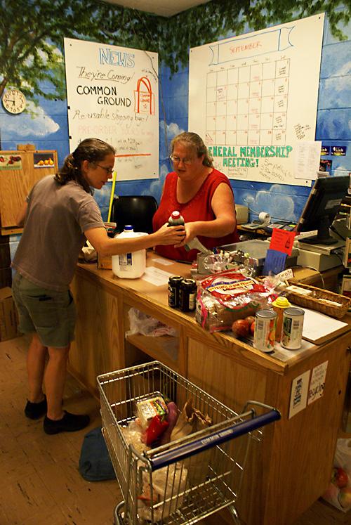 Cashier Pattie Booth Hodges shares her knowledge with frequent customer Aviva Gold at Common Ground Food Co-op on Thursday. Allison Bulow

