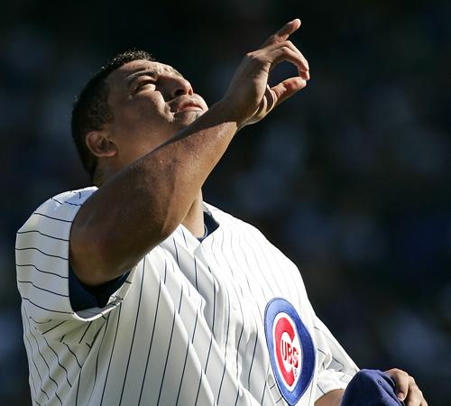 Chicago Cubs starting pitcher Carlos Zambrano points skyward after finishing the sixth inning against the Pittsburgh Pirates on Sunday. The Associated Press
