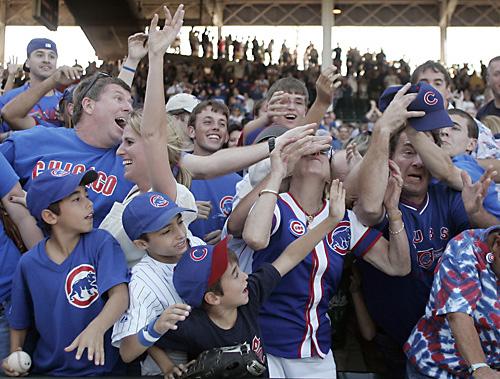 A fan displays a sign from the seats as the Cubs play the Pirates in a baseball game at Wrigley Field in Chicago, Sunday, September 23, 2007. It was the last home game of the season and the northside team is up for sale. THE ASSOCIATED PRESS, JERRY LAI
