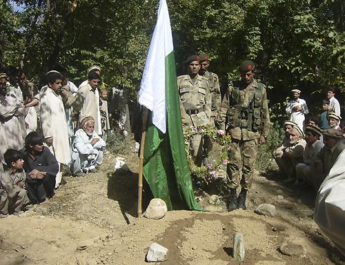 Troops of the Pakistan army pay tribute to their colleagues who were killed during a clash between security forces and militants, Tuesday, Oct. 9, 2007 in Para Chinar, near the Afghanistan border in Pakistan. Pakistani aircraft bombed a village bazaar nea THE ASSOCIATED PRESS, DILAWER HUSSAIN
