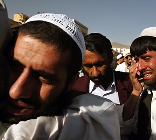 A released Afghan, one of sixteen let go after years of captivity at the U.S. prison in Guantanamo, is hugged by a relative in Kabul in this Oct. 12, 2006 file photo. Critics have long complained that military panels at Guantanamo Bay recommended continue THE ASSOCIATED PRESS, RODRIGO ABD
