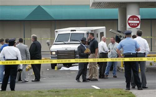 Police gather to investigate the crime scene outside a Wachovia bank in northeast Philadelphia on Thursday Oct. 4, 2007, where a robber shot and killed two armored car guards servicing an ATM outside a Northeast Philadelphia bank early Thursday, authoriti The Associated Press
