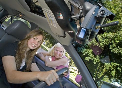 Anna Kinderman, 17, and her mother, Bette Kinderman, show off a small camera that is installed near the rear-view mirror to record unsafe events when the teenager drives in Madison, Wis. The monitoring device provided through Madison-based American Fam THE ASSOCIATED PRESS, ANDY MANIS
