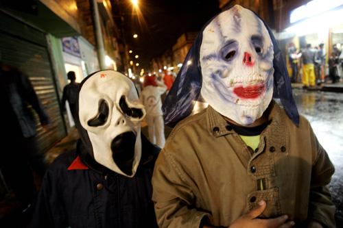 Two children dressed in costume to celebrate Halloween walks as they collect candies through a neighborhood of Bogota, Colombia, Tuesday, Oct. 31, 2006. Two-thirds of parents say their children will trick-or-treat this Halloween. The Associated Press
