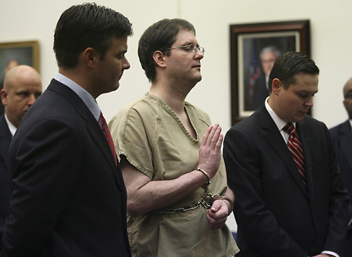 Flanked by defense attorneys Michael Kielty, left, and Ethan Corlija, right, Michael Devlin raises his right hand to be sworn in as he appears in St. Louis County Circuit Court to answer charges against him on Tuesday in Clayton, Mo. Devlin pleaded guilty THE ASSOCIATED PRESS, ROBERT COHEN
