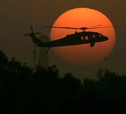A U.S. Army Black Hawk helicopter flies as the sun sets over Baghdad on Tuesday. The Iraqi government on Tuesday approved draft legislation lifting immunity for foreign private security companies. Marko Drobnjakovic, The Associated Press
